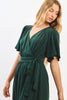 Woman wearing a green dress against a white background