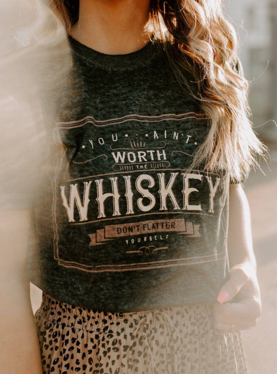 Woman wearing a graphic t-shirt with text outdoors