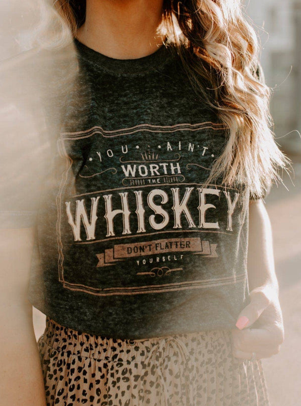 Woman wearing a graphic t-shirt with text outdoors