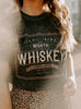 Woman wearing a graphic t-shirt with text outdoors