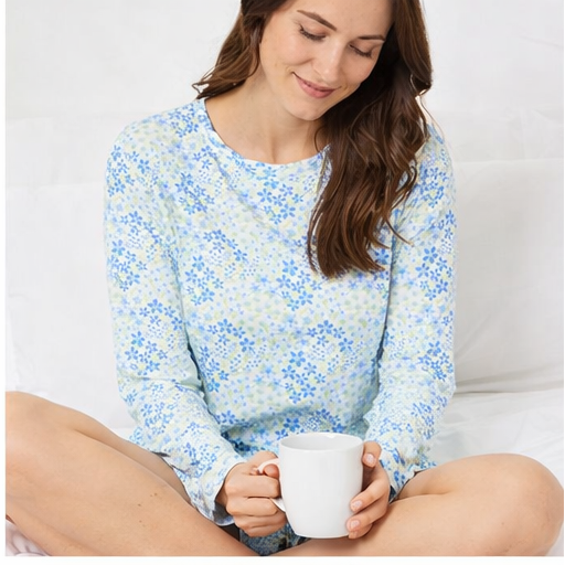 Woman wearing a blue floral pajama set in various poses on a white background