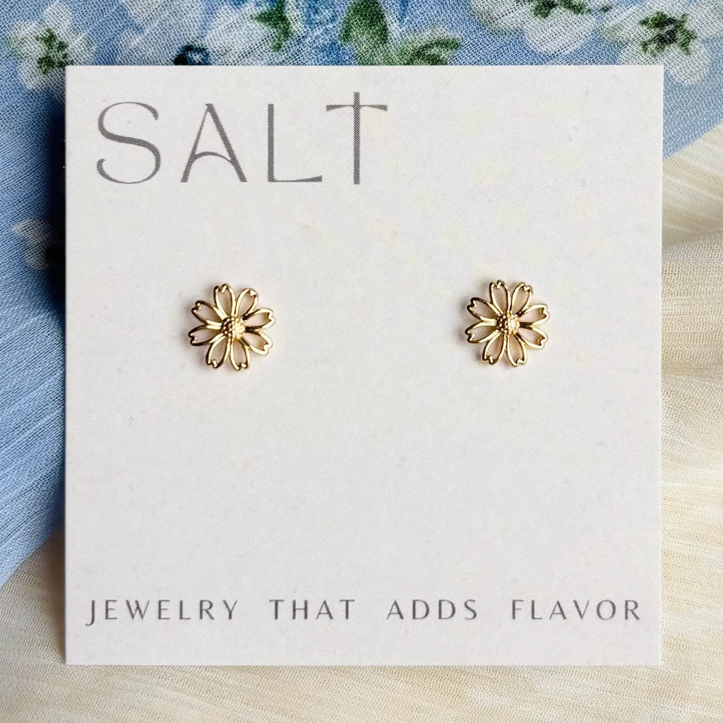 Gold flower-shaped earrings on a 'SALT' branded card with floral background