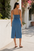 Girl wearing denim midi dress with spaghetti straps and smocked back
